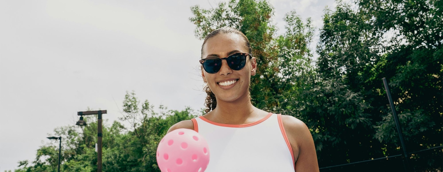 a woman holding a paddle and a ball