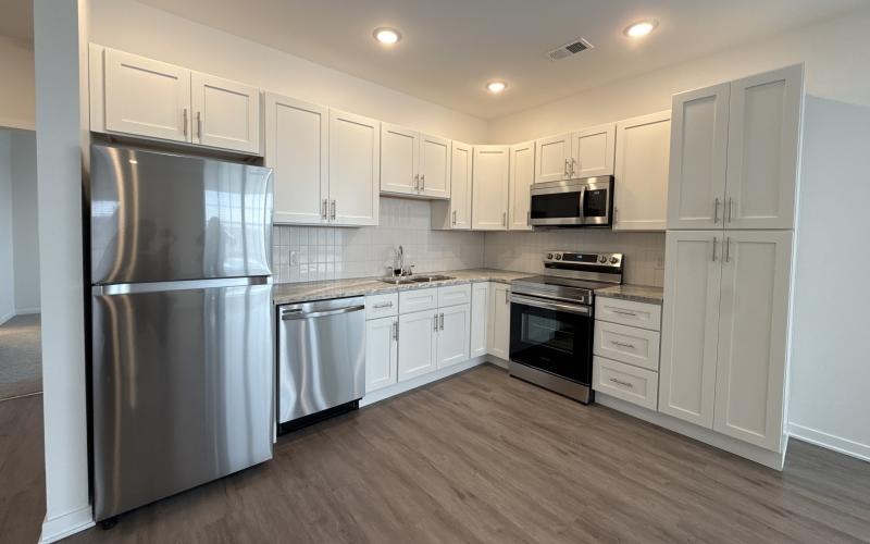 a kitchen with white cabinets