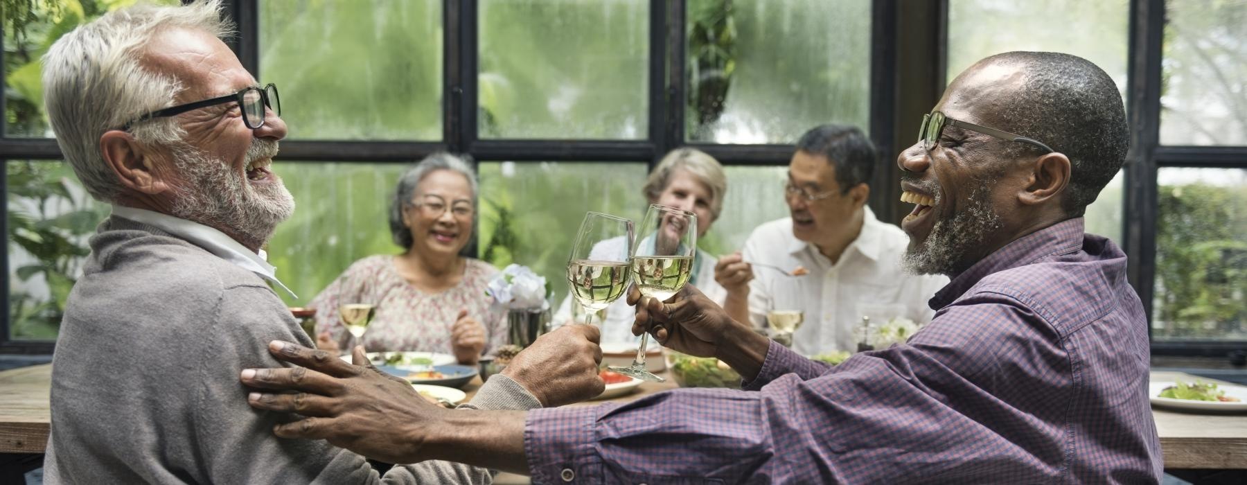 a group of people sitting at a table drinking wine