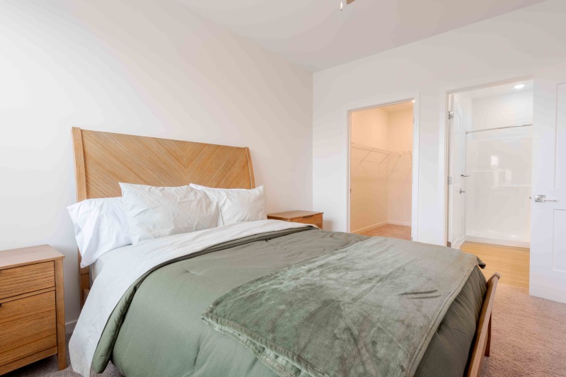 a bed with a green blanket