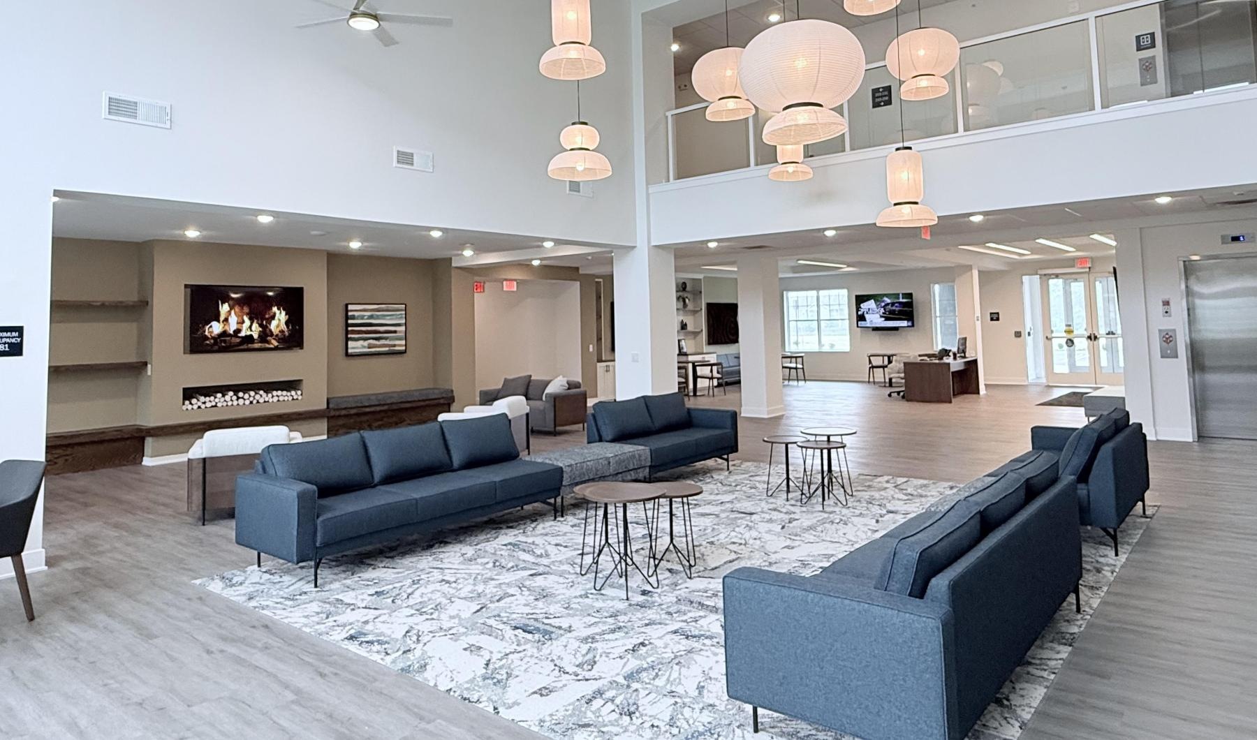 a living room with a fireplace and blue couches