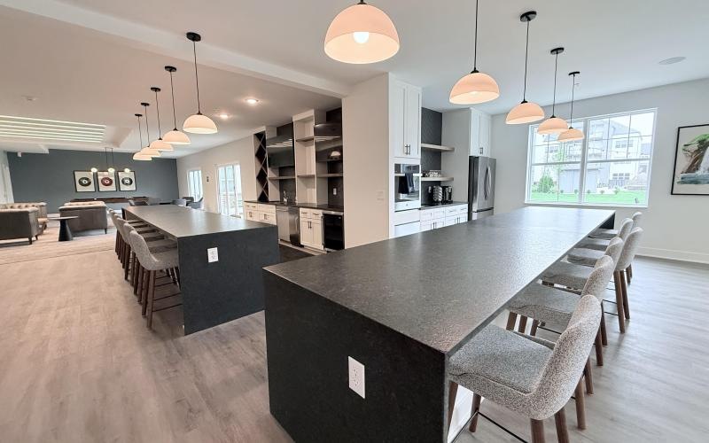 a kitchen with a bar and chairs