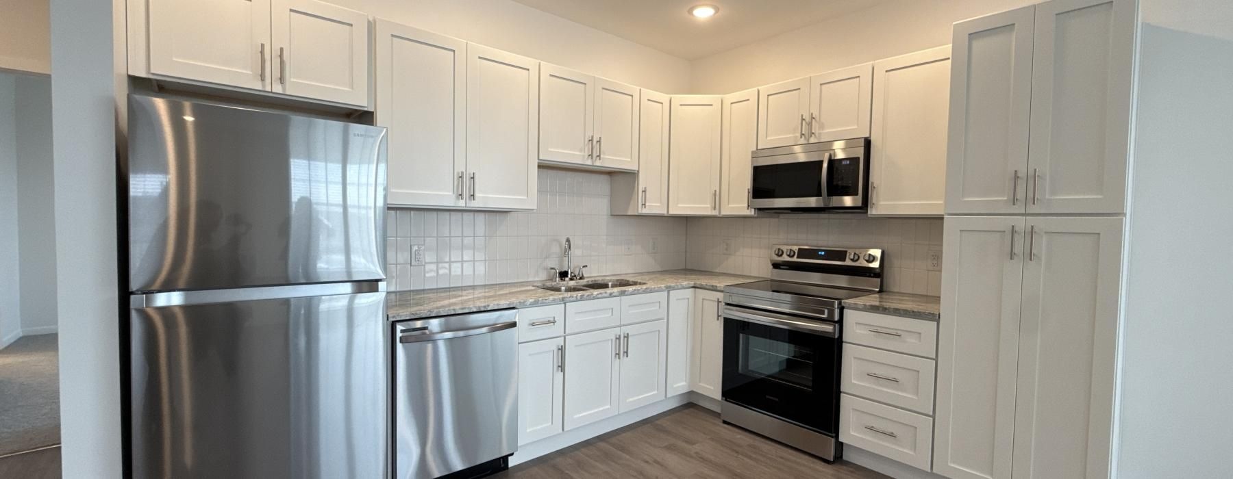 a kitchen with white cabinets