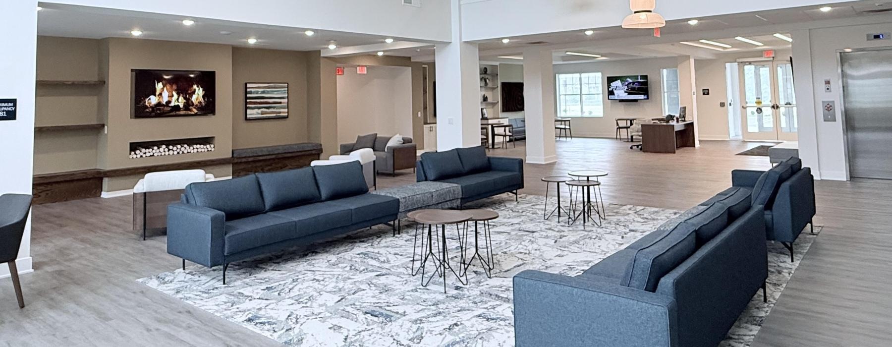 a living room with a fireplace and blue couches