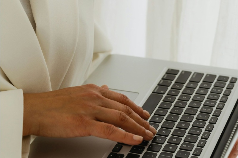 a person typing on a laptop