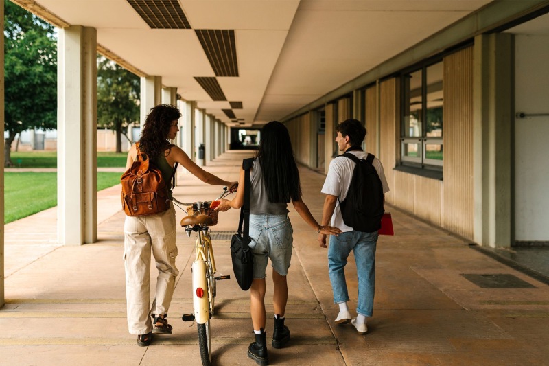 a group of people walking down a sidewalk
